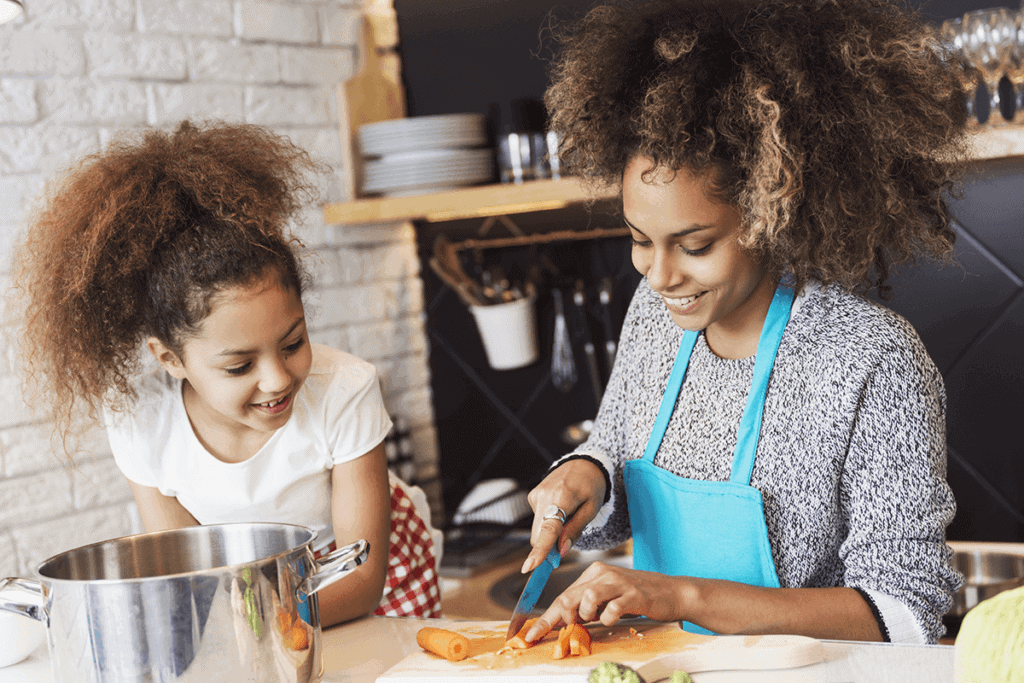 woman and daughter cooking together
