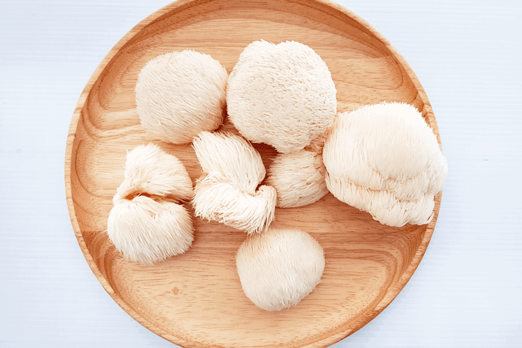 Lion's mane mushrooms on a wooden plate.