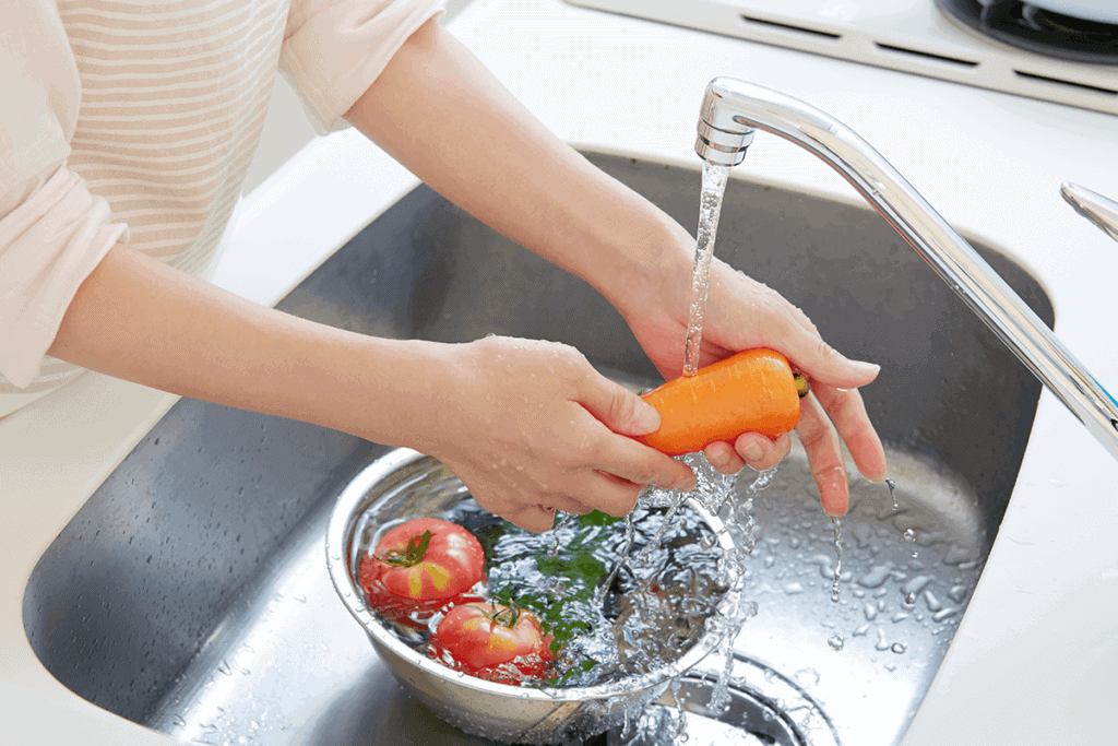 person washing vegetables