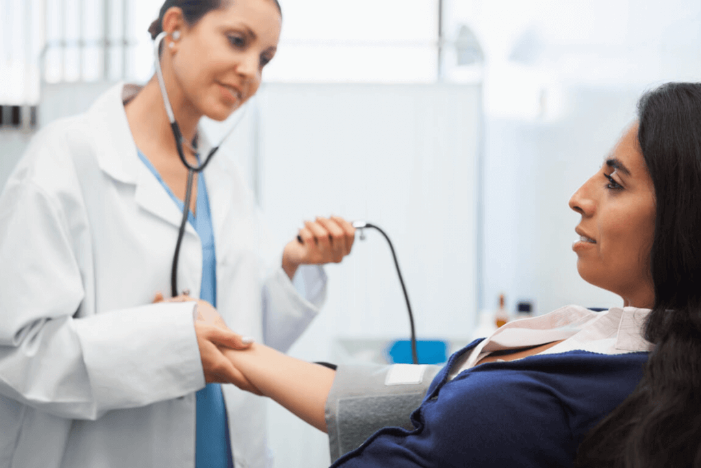 practitioner taking patient's blood pressure