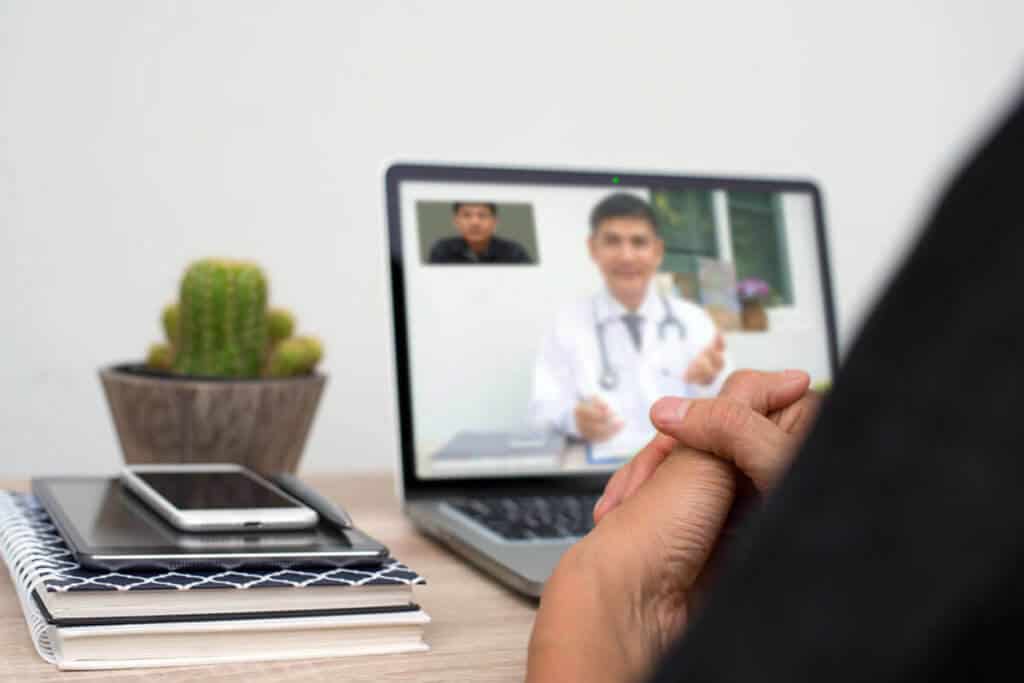 practitioner on a laptop screen talking to their patient