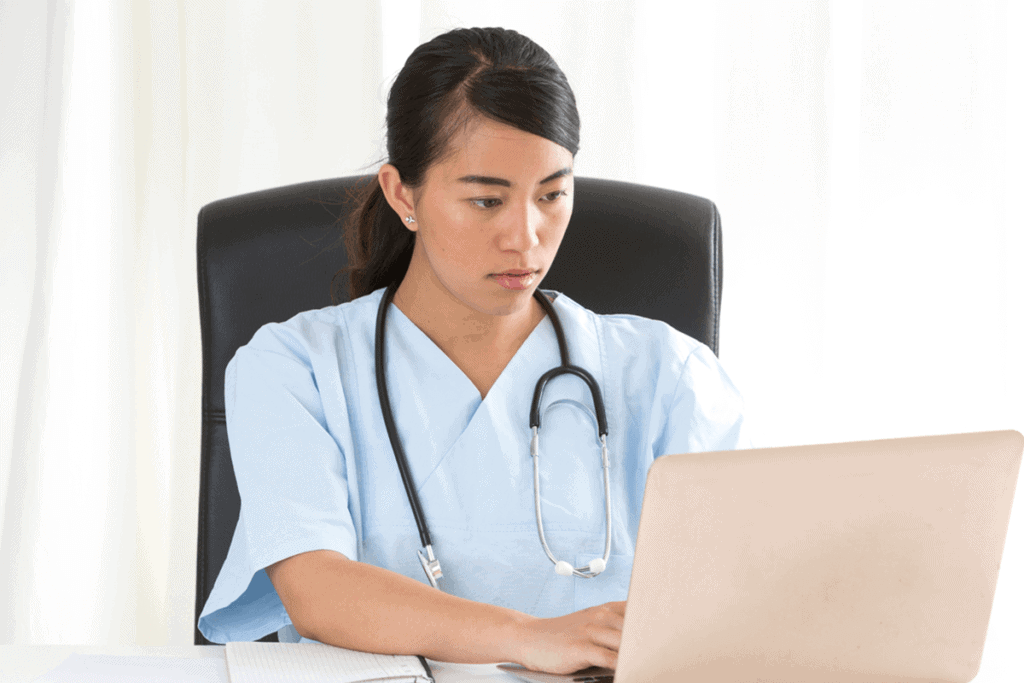 female healthcare practitioner working on laptop
