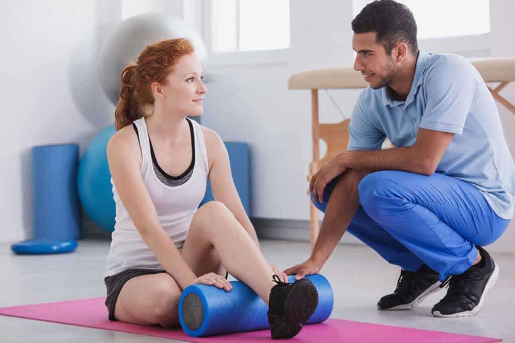patient with physical therapist working on exercises
