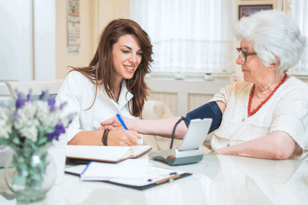 nurse taking an elderly woman's blood pressure