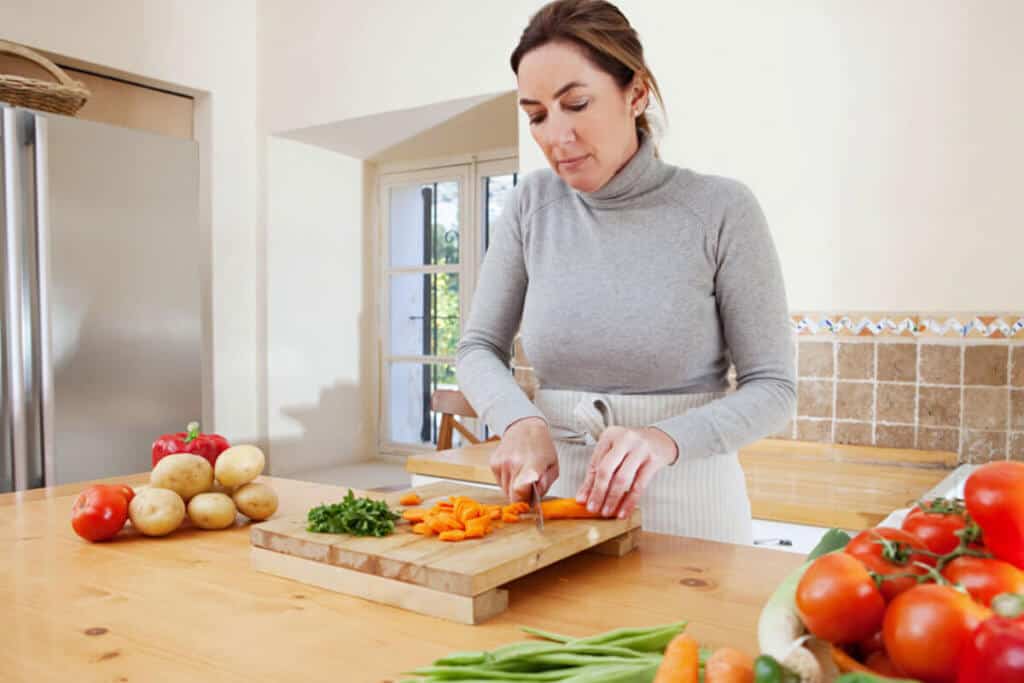woman in her kitchen putting up vegetables