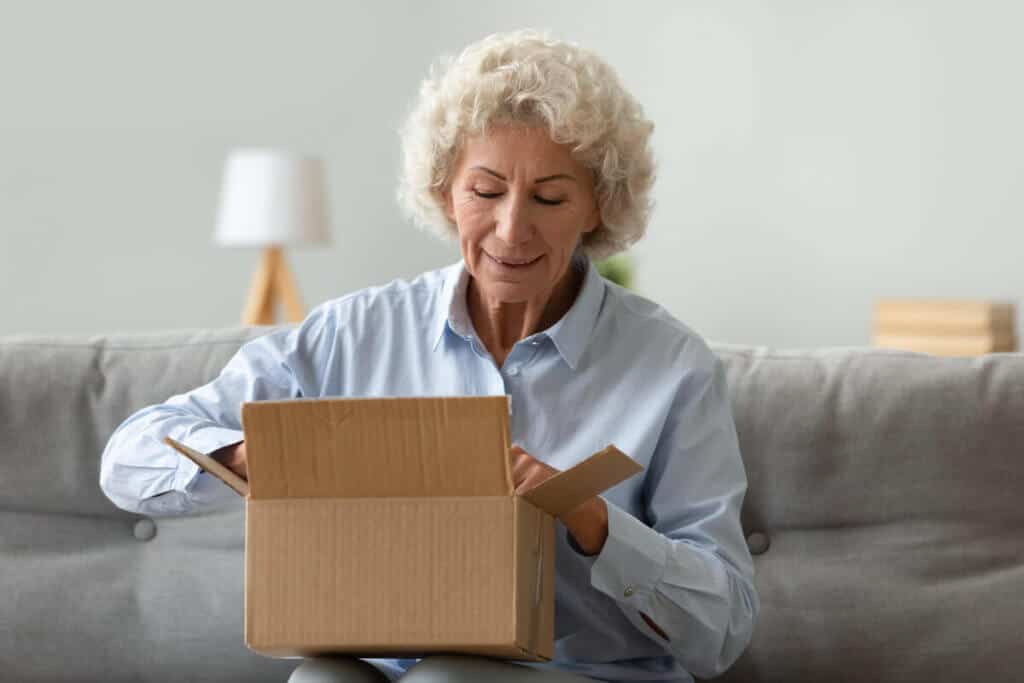 woman opening up cardboard box