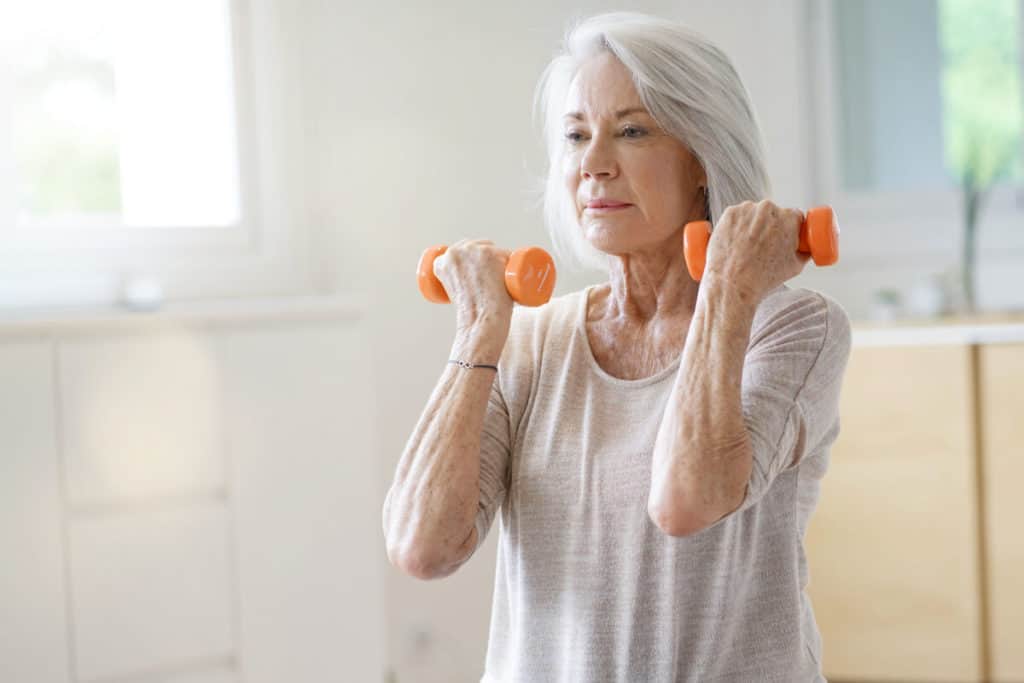 Image of elderly woman lifting weights