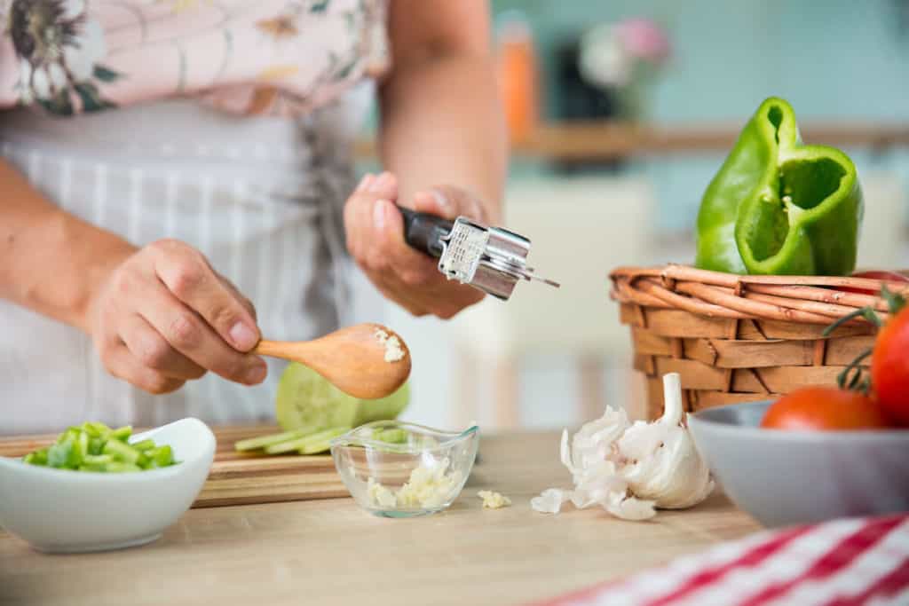 Image of woman crushing garlic