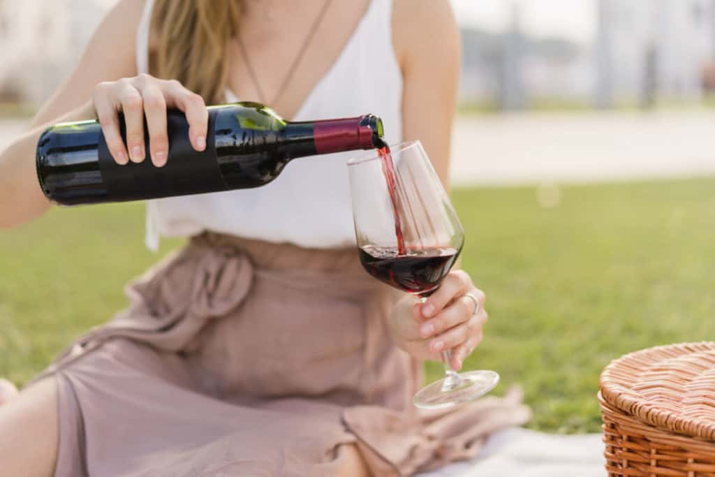 Image of woman pouring a glass of wine