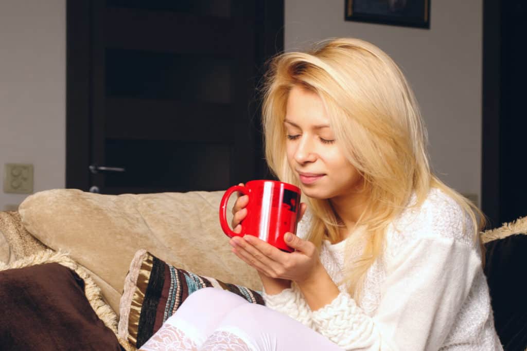 Image of woman holding coffee cup