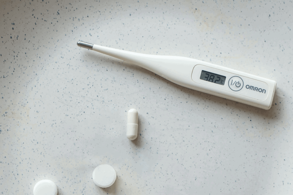 Image of a thermometer and pills