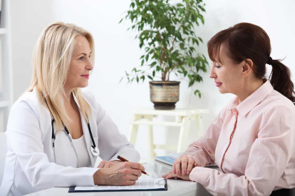 Image of woman consulting doctor