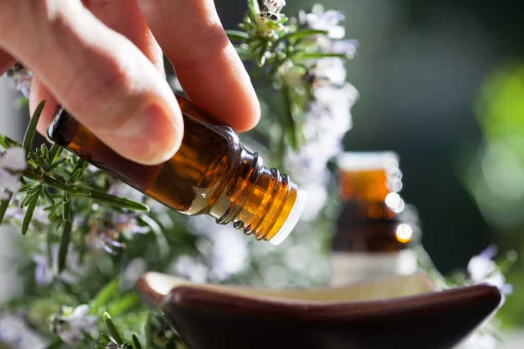 Hand holding a essential oil bottle