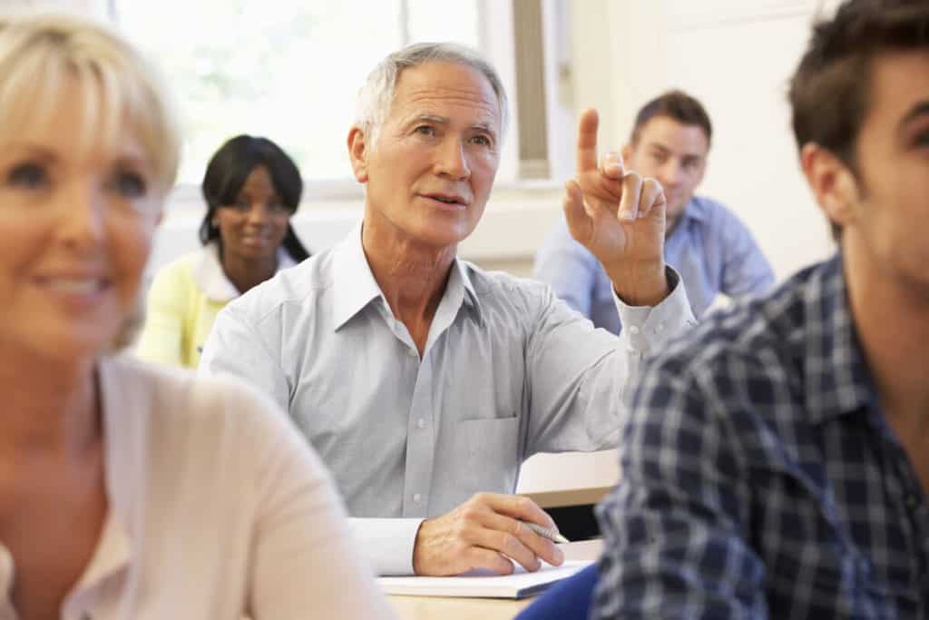 Man listening intently in a classroom