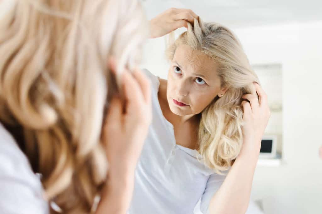 Woman combing through her hair