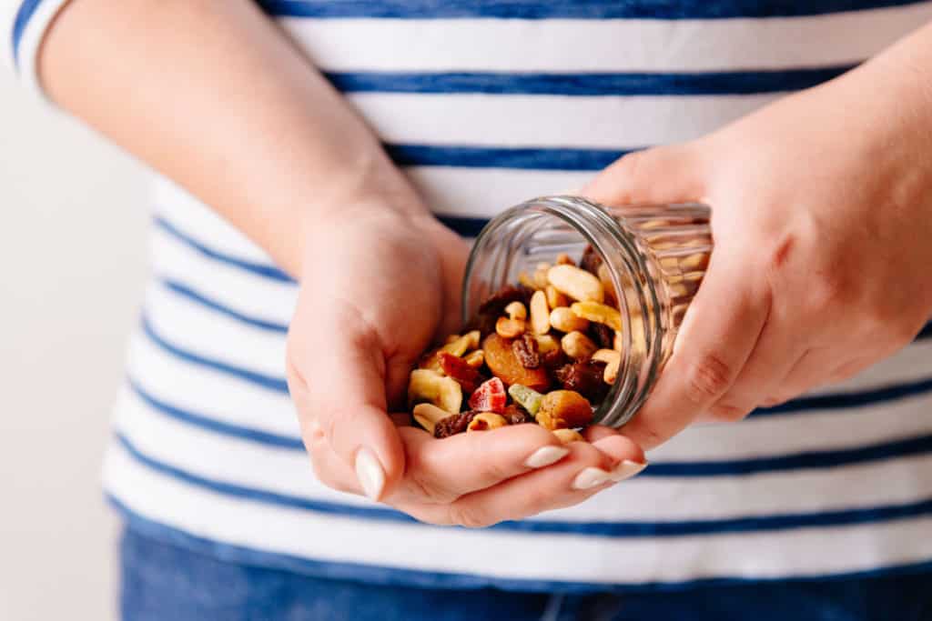 Woman pouring nuts into her hand
