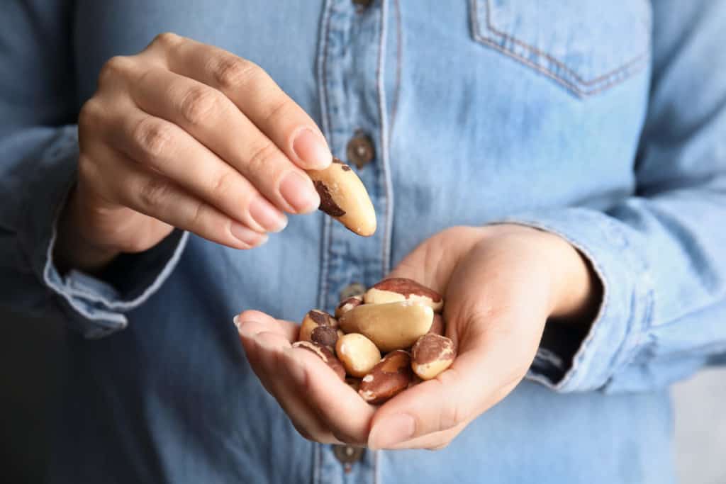 Person holding a handful of nuts