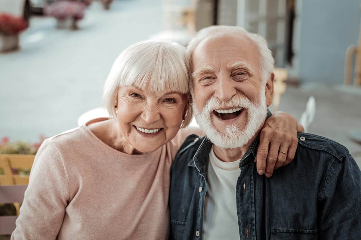 Two elderly people laughing 