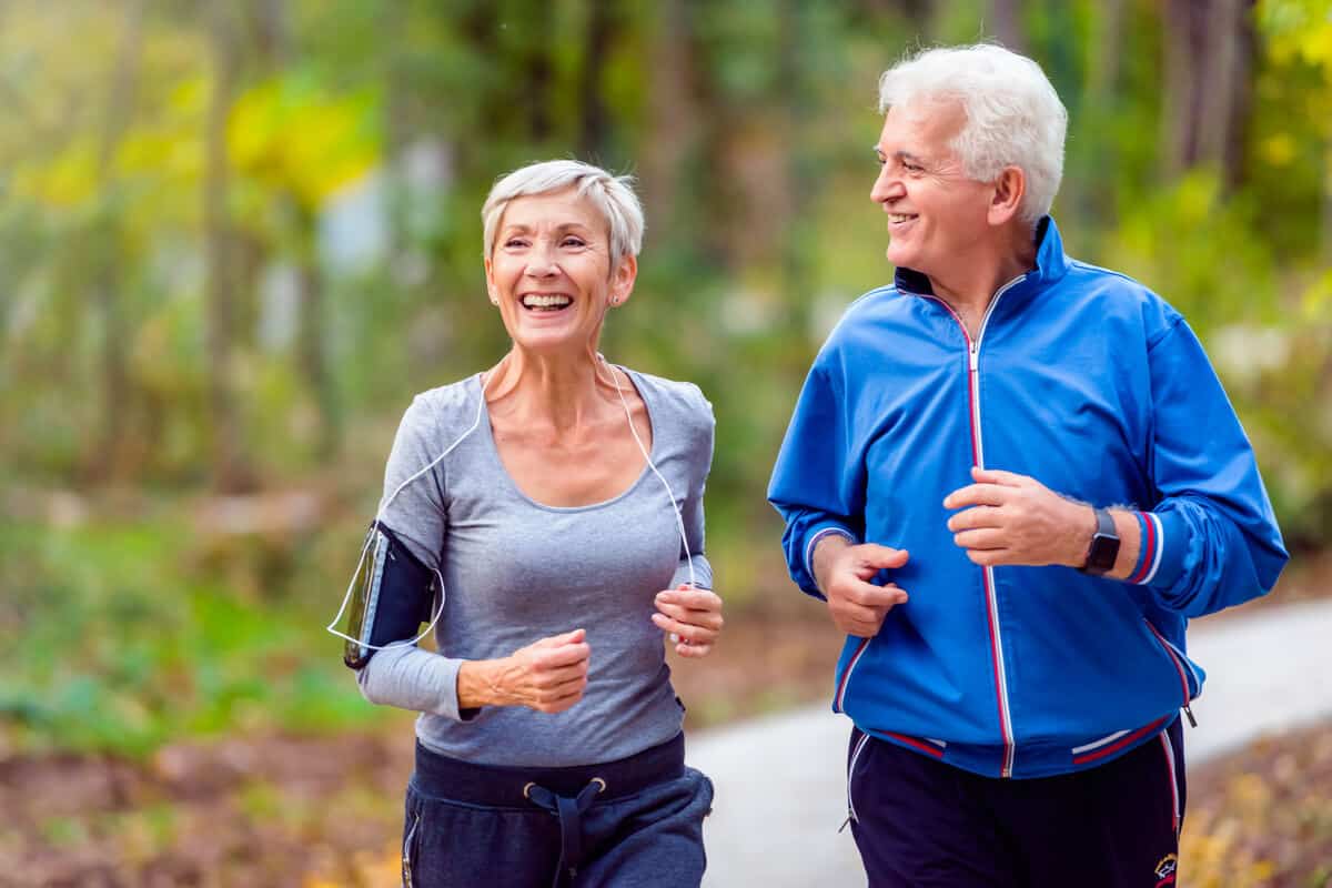 Two elderly people running 