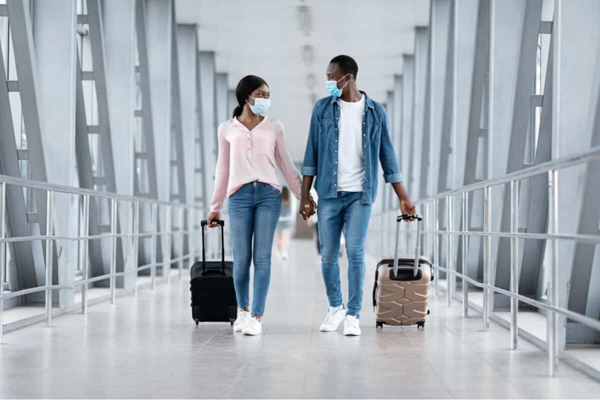 A man and a woman walking in an airport
