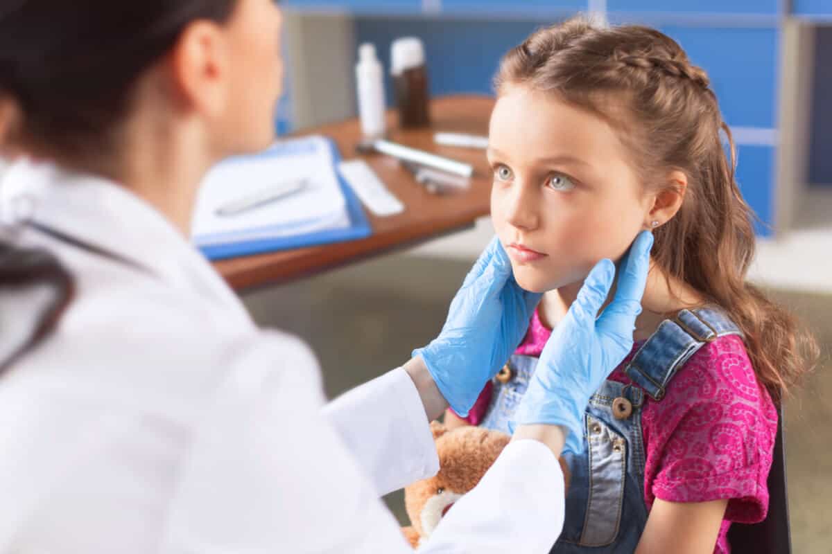 Doctor examining a childs lymph nodes