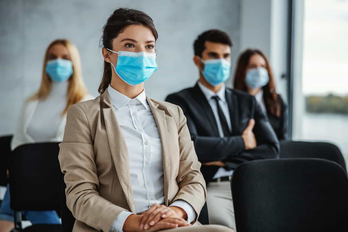 Patients sitting in a room together with masks on