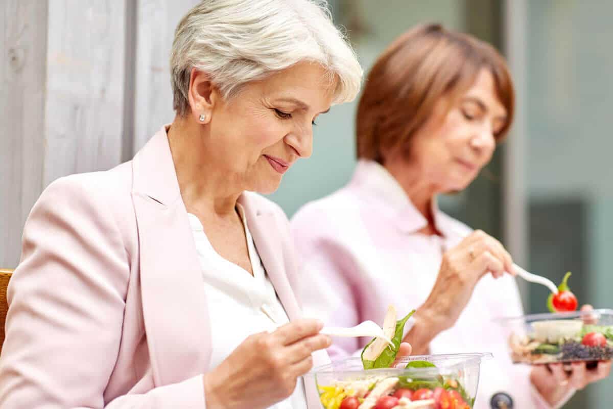 Older women eating salads