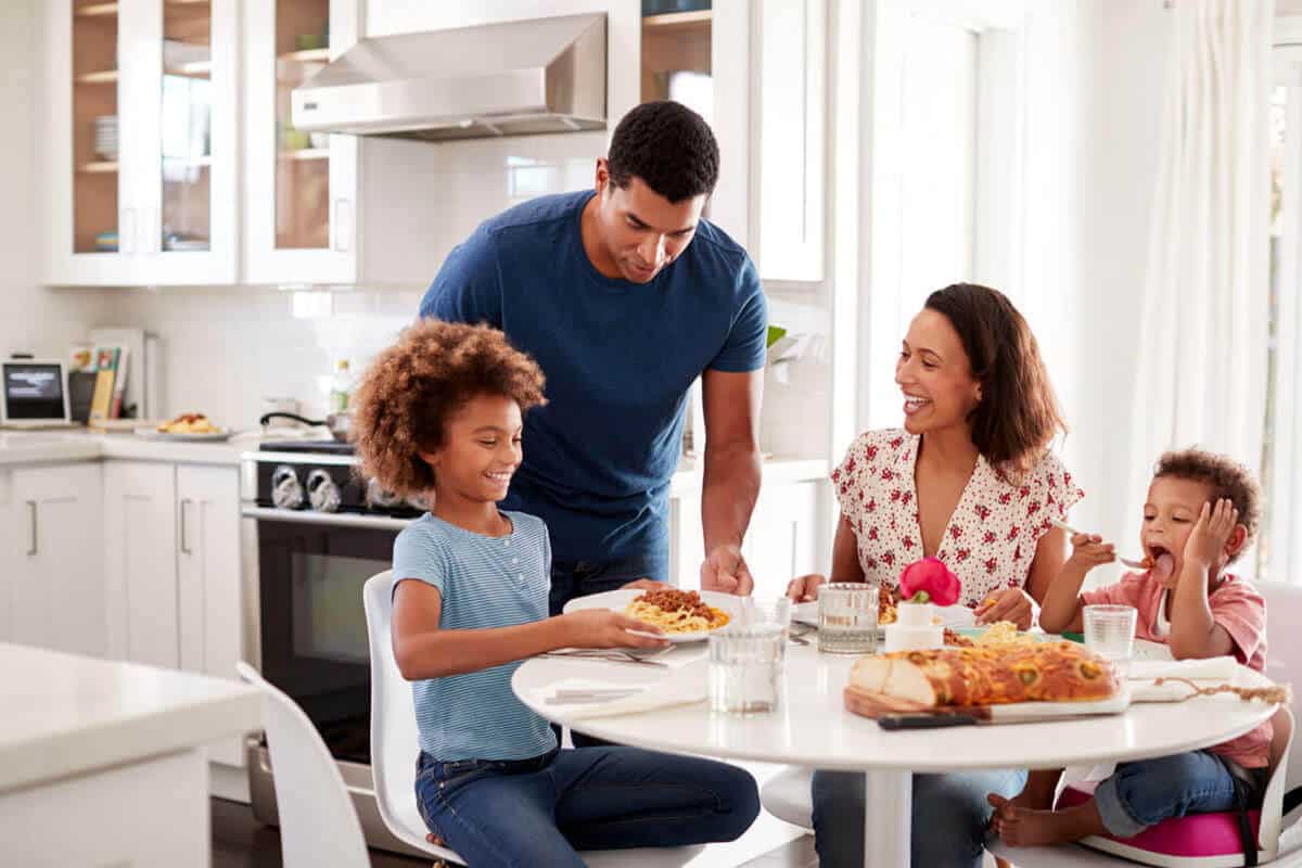 family of four eating at dinning table