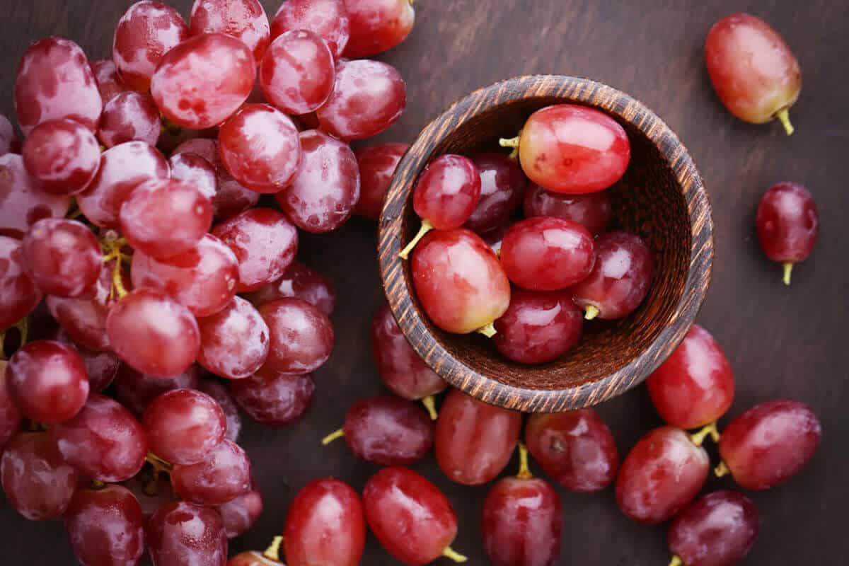 red grapes in a pile on a table