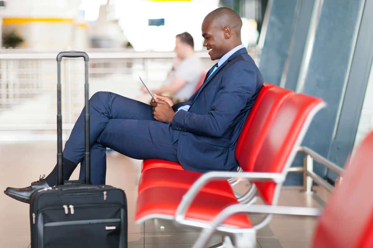 man sitting at the airport with luggage
