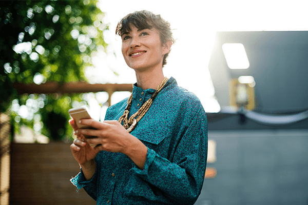 smiling woman holding a mobile device