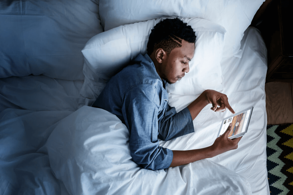 circadian rhythms man using an ipad in bed