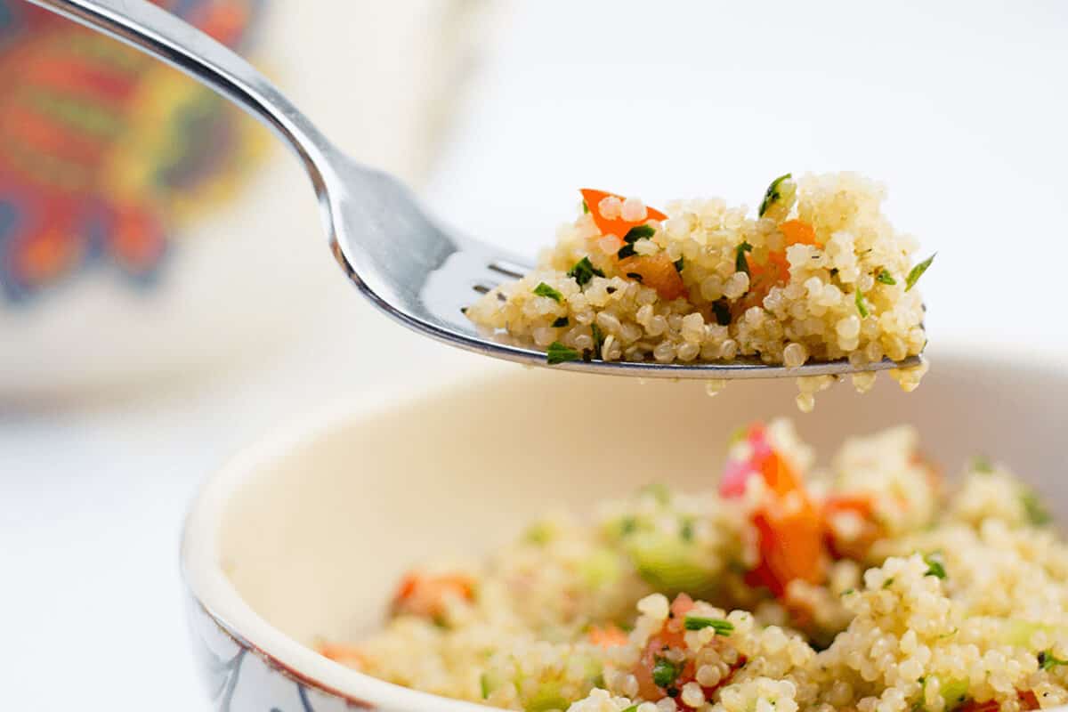 quinoa in a bowl fork lifting with quinoa