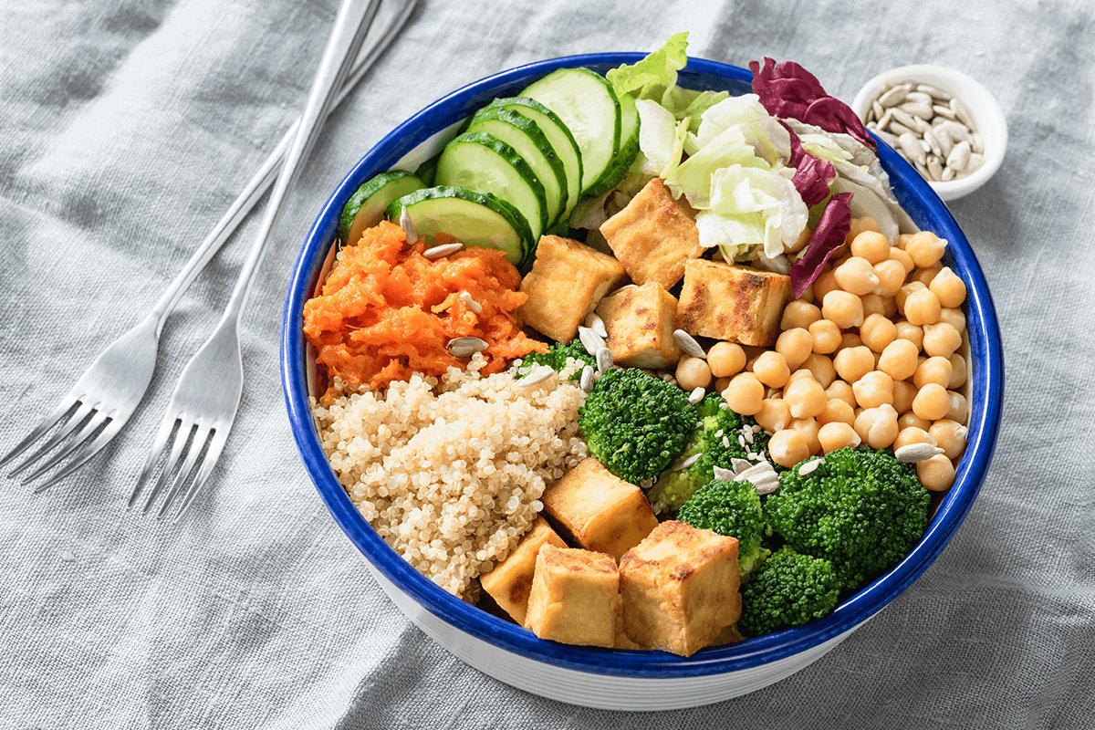bowl of assorted foods including grains, vegetables, tofu and chickpeas