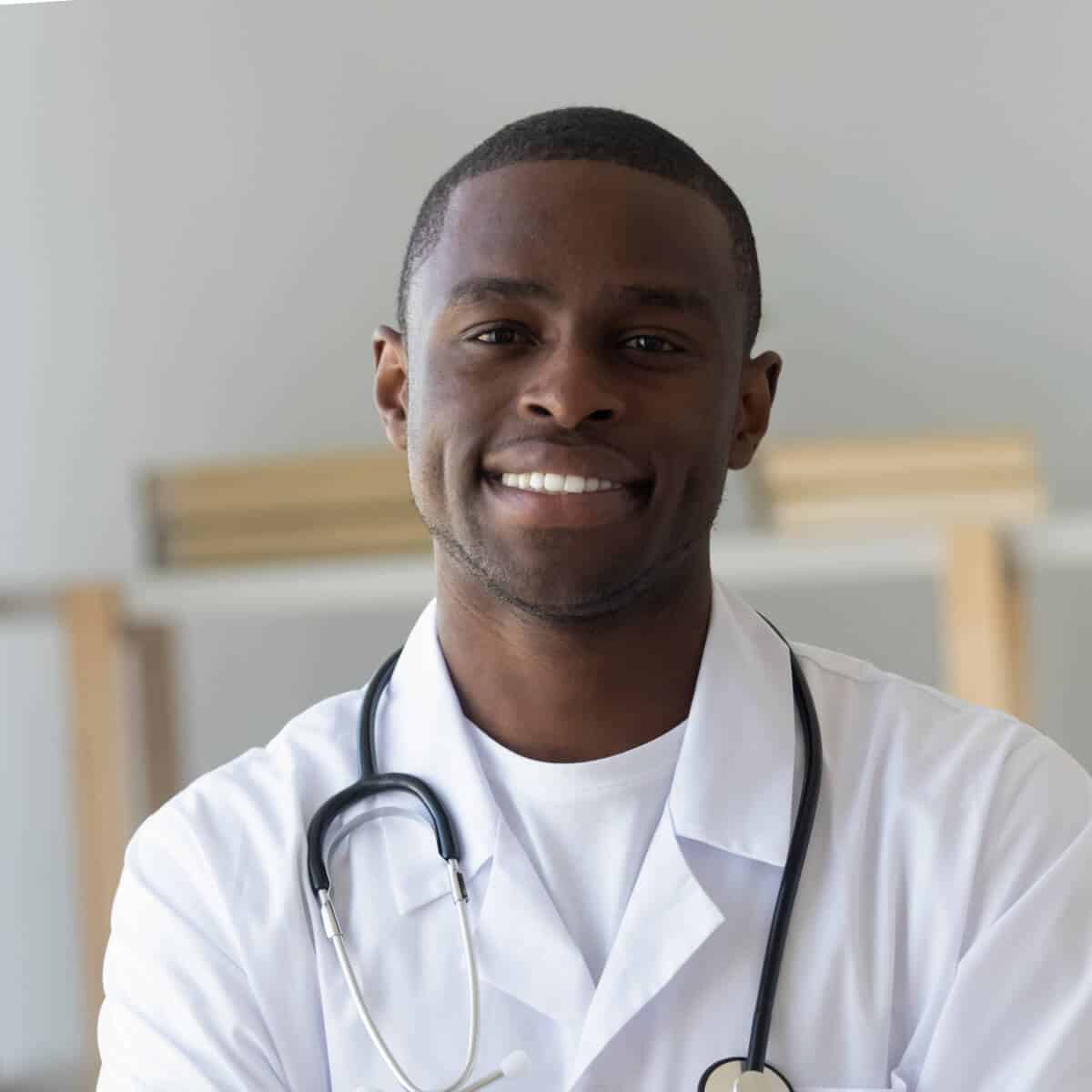 a smiling male doctor in a white coat