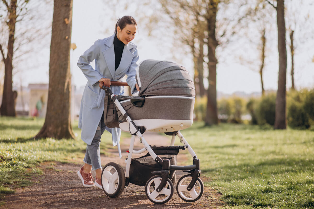 postpartum recovery tips woman pushing stroller