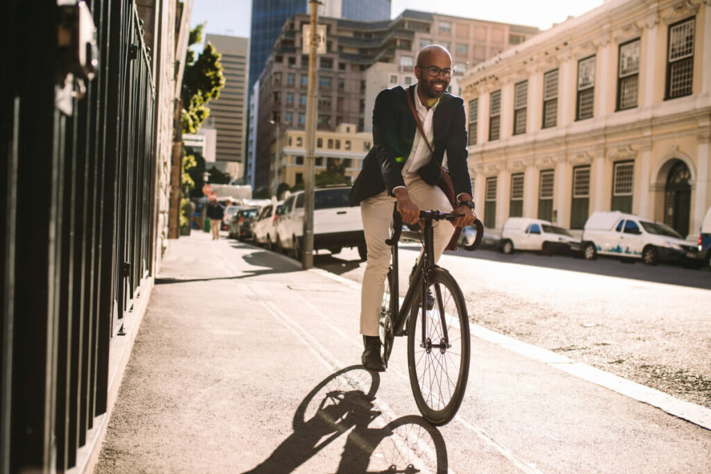 Man riding bicycle down a city street. 
