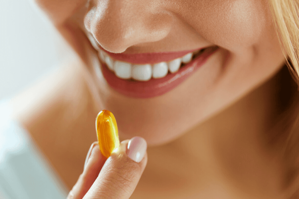 woman taking a omega 3 fatty acid supplement